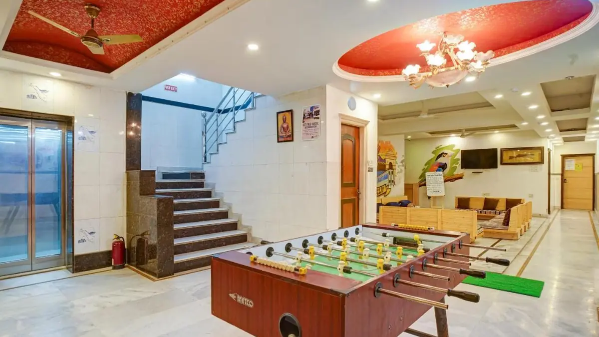 The hotel lobby, with a table football, the stairs and the lift